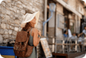 Woman walking next to shops