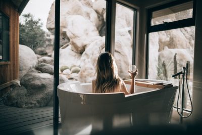 Woman in a bathtub looking out the window